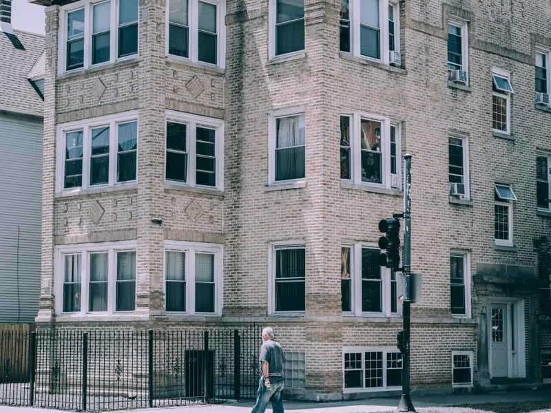 Classic Chicago brick three-flat with bay windows, the kind of building Stellar manages